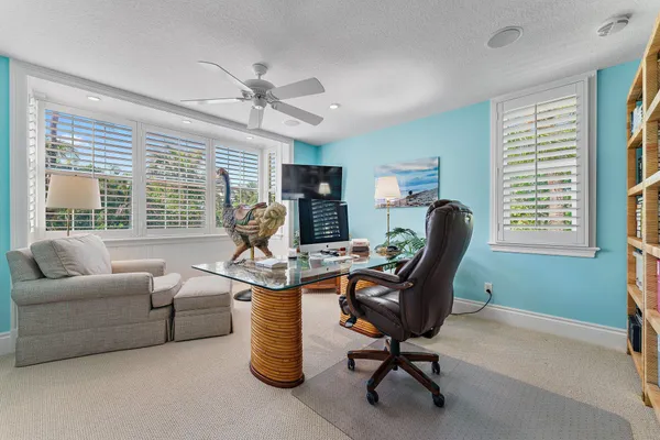 a view of a livingroom with workspace and a window