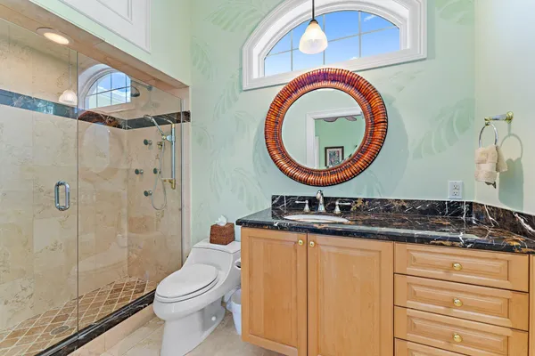 a bathroom with a toilet a sink and a mirror