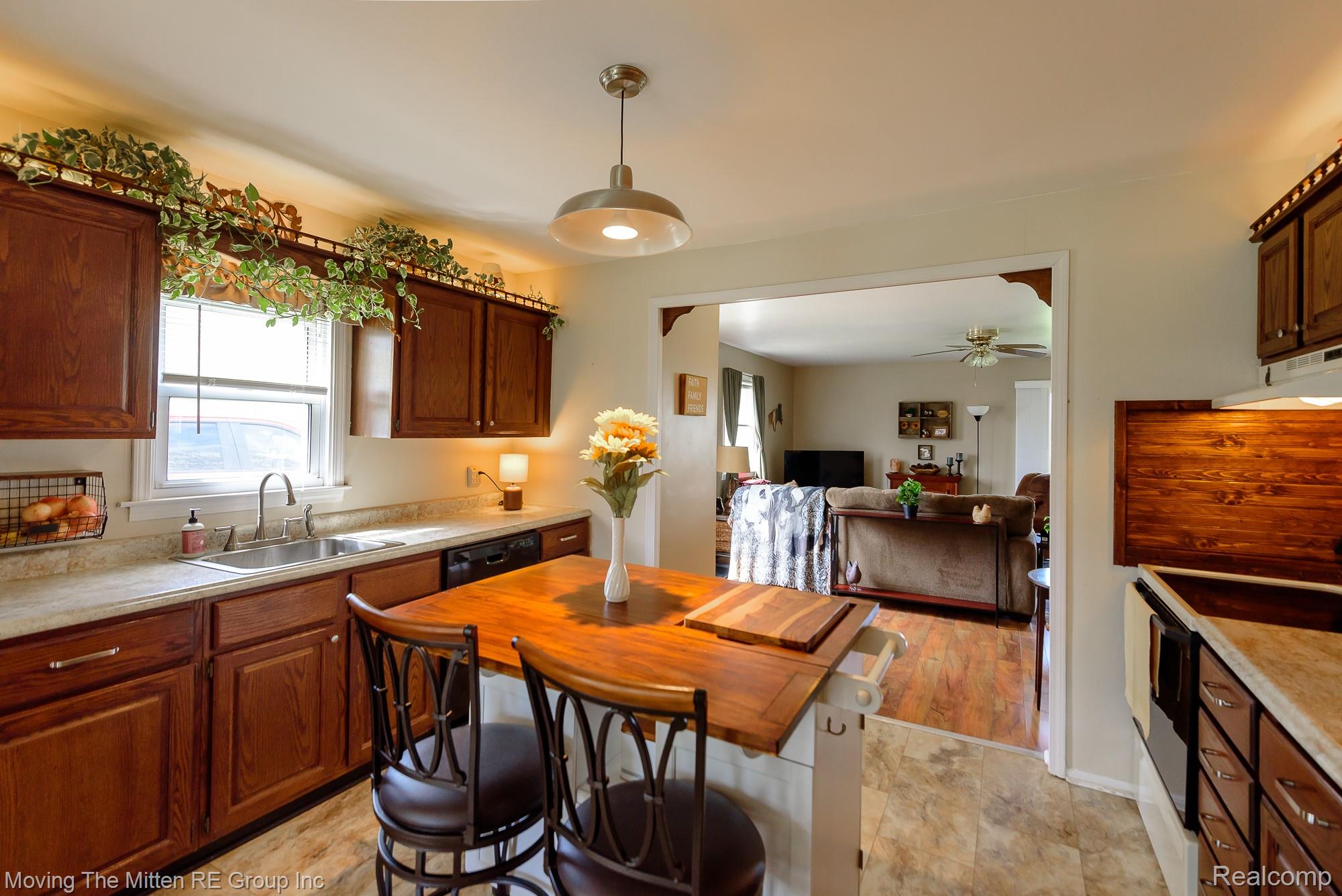 9260 Pitman Road Ypsilanti, MI 48197 - Photo 45 of 45 Kitchen featuring open floor plan, range with electric stovetop, hanging light fixtures, dishwasher, and a ceiling fan