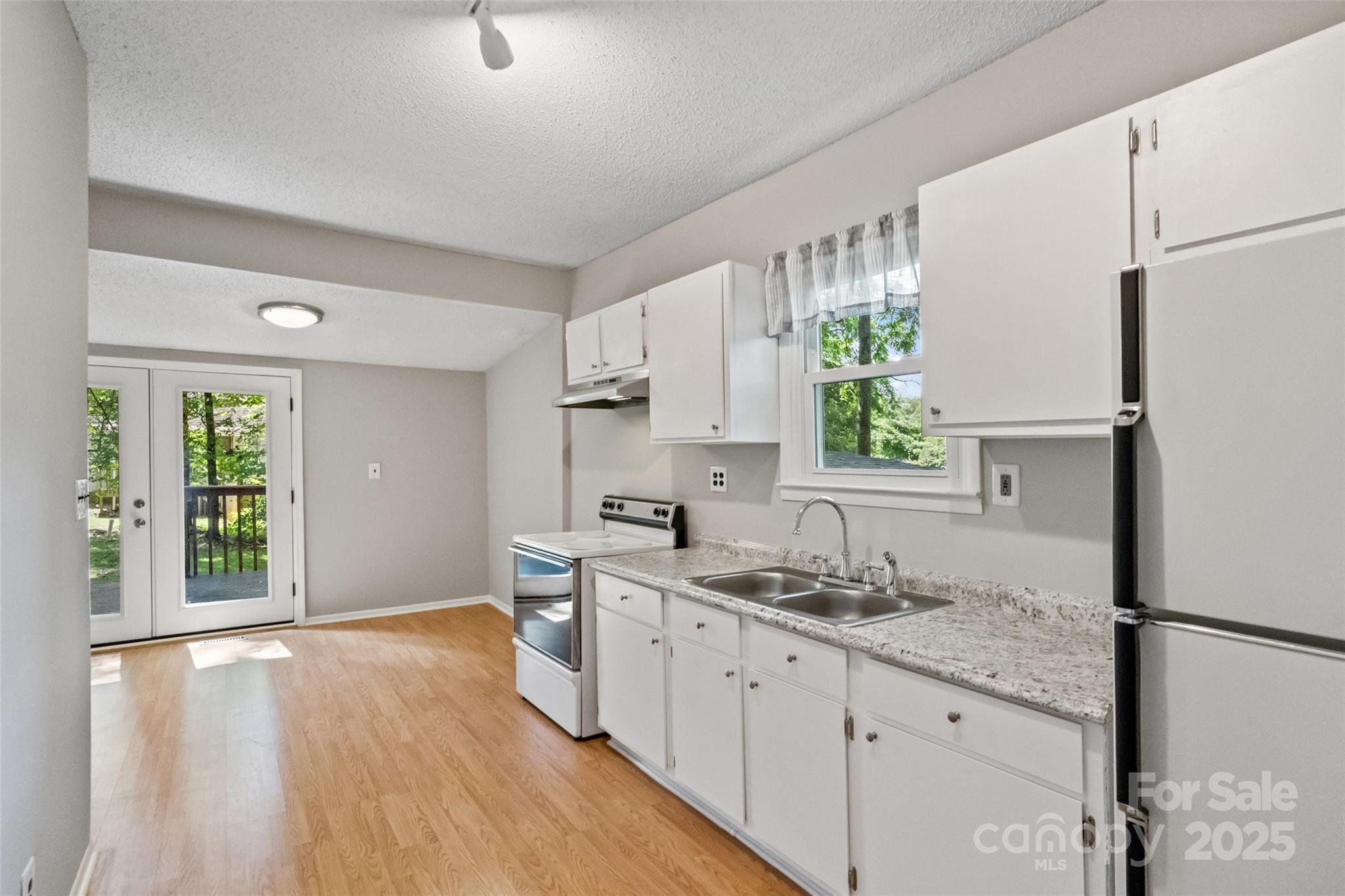 29 7th Street York, SC 29745 - Photo 17 of 22 a kitchen with granite countertop a sink stove and refrigerator