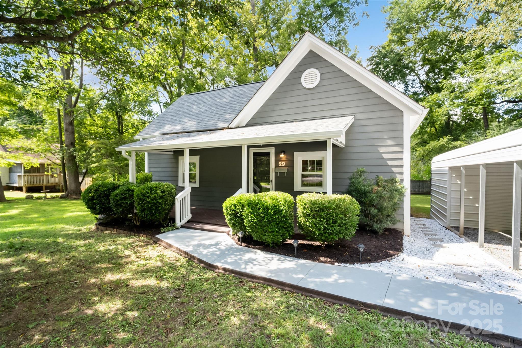 29 7th Street York, SC 29745 - Photo 2 of 22 a front view of a house with a yard and potted plants