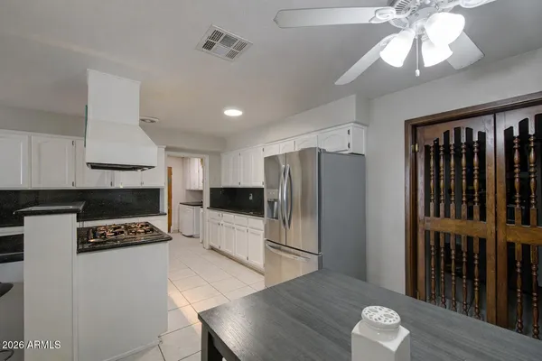 a kitchen with stainless steel appliances a refrigerator a stove a sink and a stove