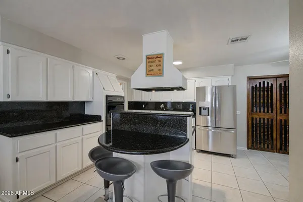 a kitchen with stainless steel appliances a stove a sink and a refrigerator
