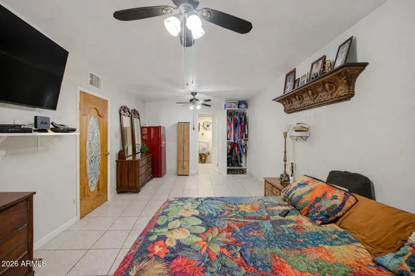 a bedroom with a bed and a flat screen tv