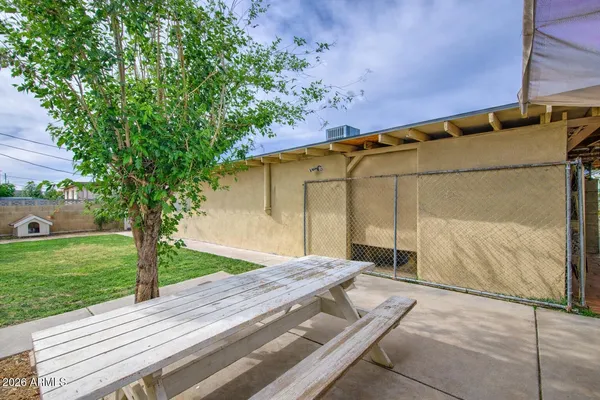 a backyard of a house with outdoor seating