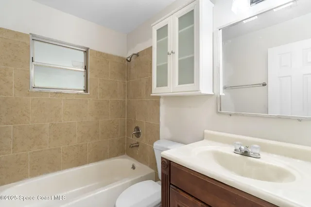 a view of a room with wooden floor and white walls