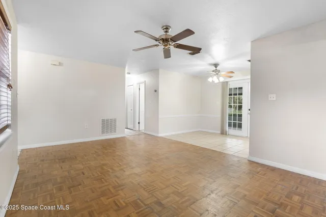 a kitchen with cabinets and wooden floor