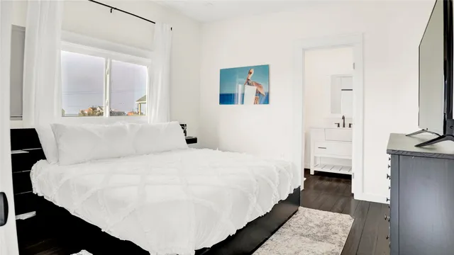 a large white bed in a white room