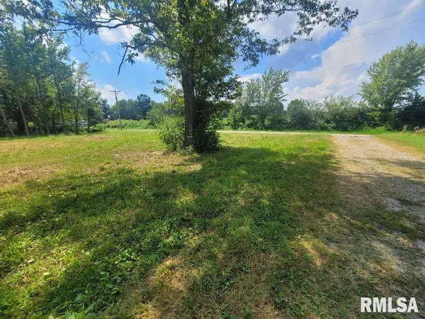 a view of outdoor space with green field and trees all around
