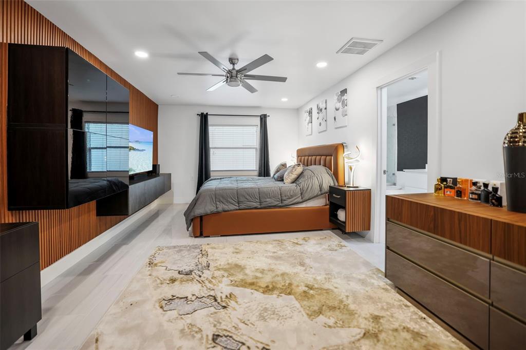 16015 Redington Drive Redington Beach, FL 33708 - Photo 26 of 60 a bed room with a bed and a flat screen tv