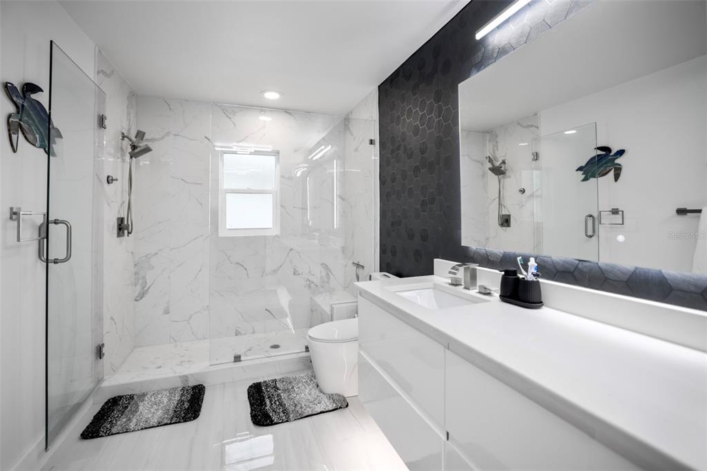 16015 Redington Drive Redington Beach, FL 33708 - Photo 30 of 60 a bathroom with a sink toilet tub and shower