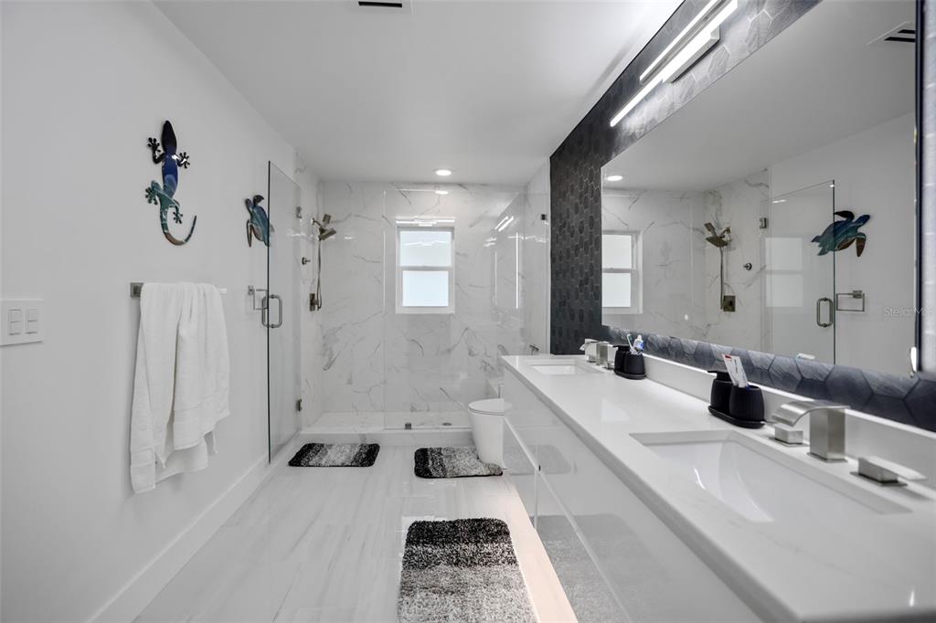 16015 Redington Drive Redington Beach, FL 33708 - Photo 31 of 60 a bathroom with a tub sink and mirror