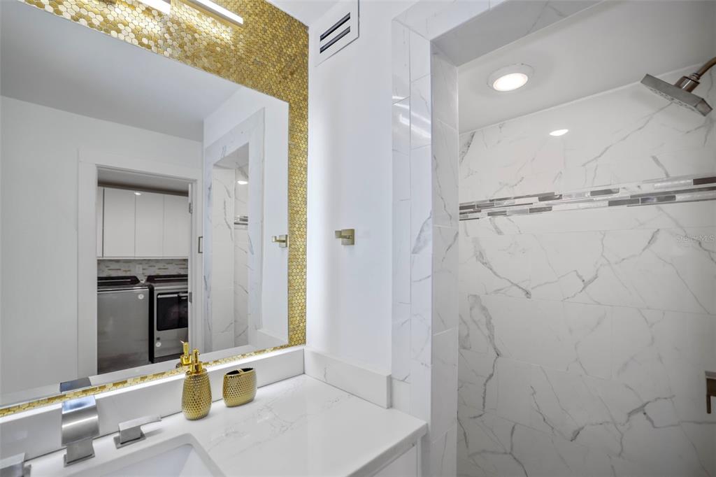 16015 Redington Drive Redington Beach, FL 33708 - Photo 34 of 60 a bathroom with a sink and a mirror