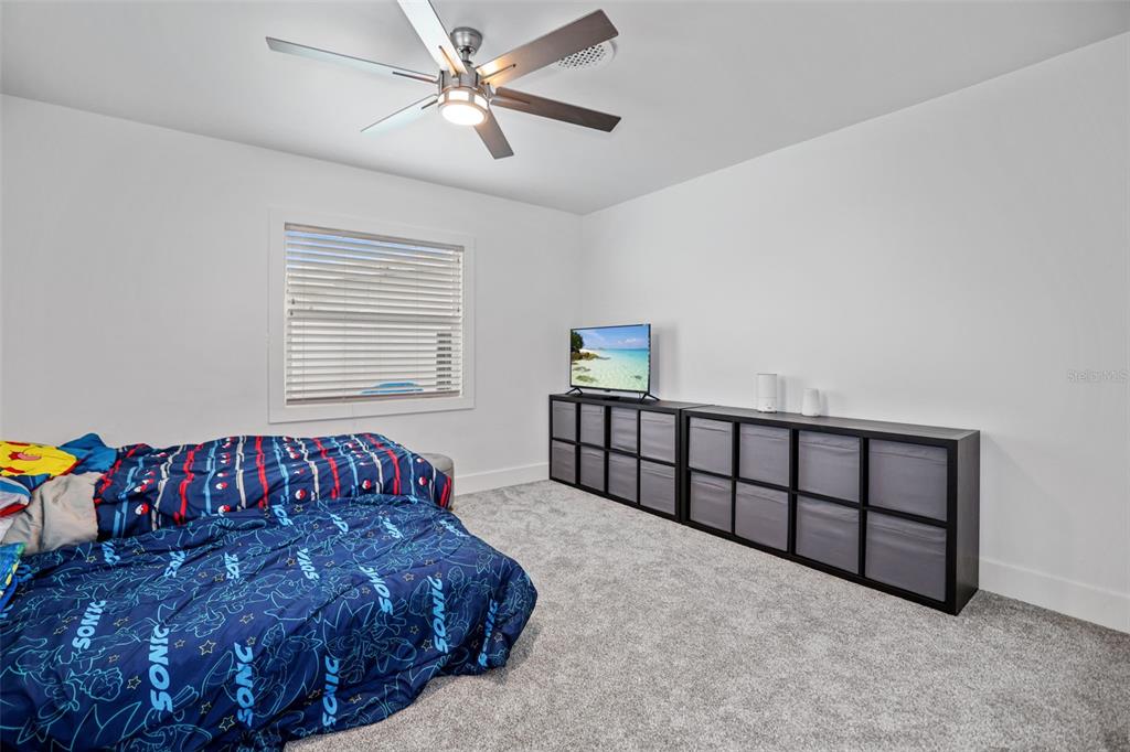 16015 Redington Drive Redington Beach, FL 33708 - Photo 39 of 60 a bedroom with a bed and a chandelier