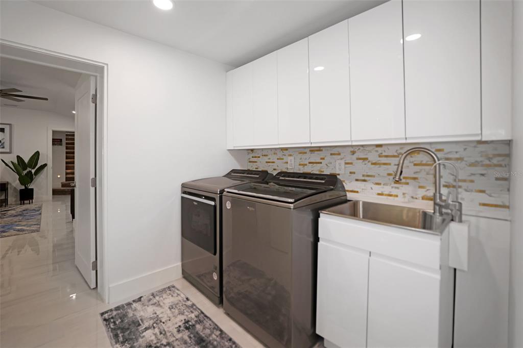 16015 Redington Drive Redington Beach, FL 33708 - Photo 41 of 60 a utility room with sink dryer and washer