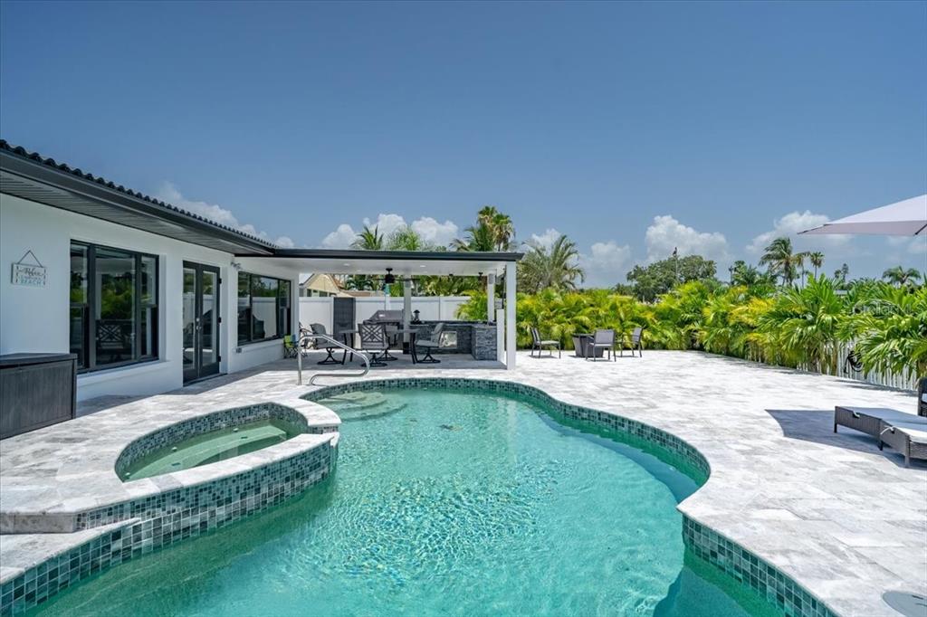 16015 Redington Drive Redington Beach, FL 33708 - Photo 43 of 60 a view of a house with swimming pool and sitting area