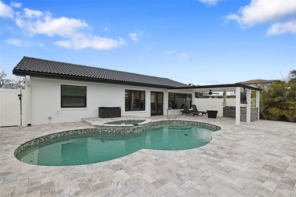 16015 Redington Drive Redington Beach, FL 33708 - Photo 45 of 60 a view of a house with swimming pool and porch