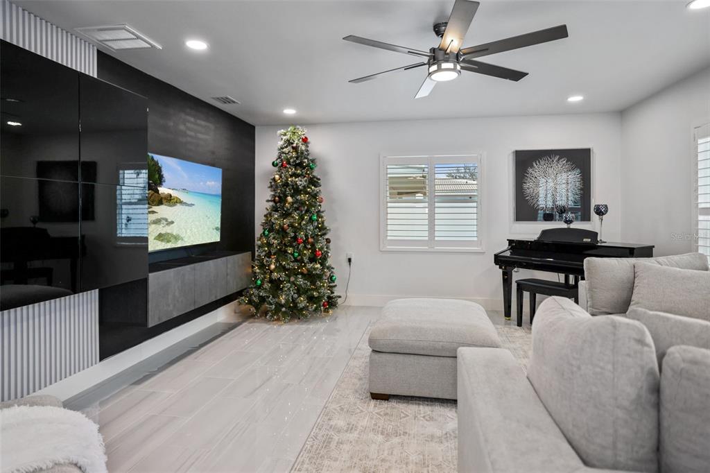 16015 Redington Drive Redington Beach, FL 33708 - Photo 9 of 60 a living room with furniture and a flat screen tv