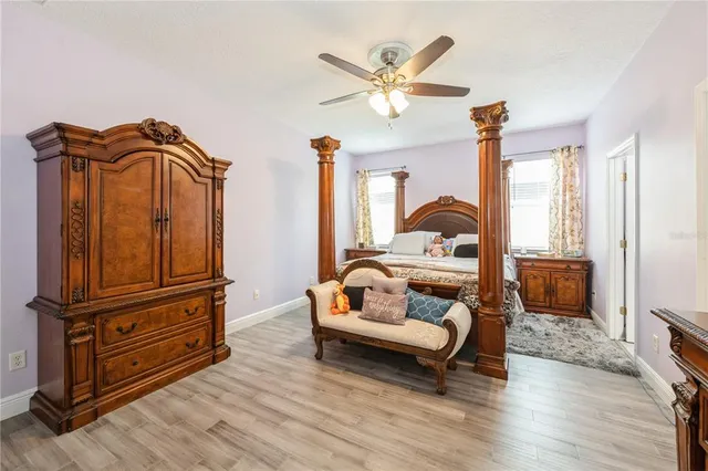 a bedroom with furniture and wooden floor