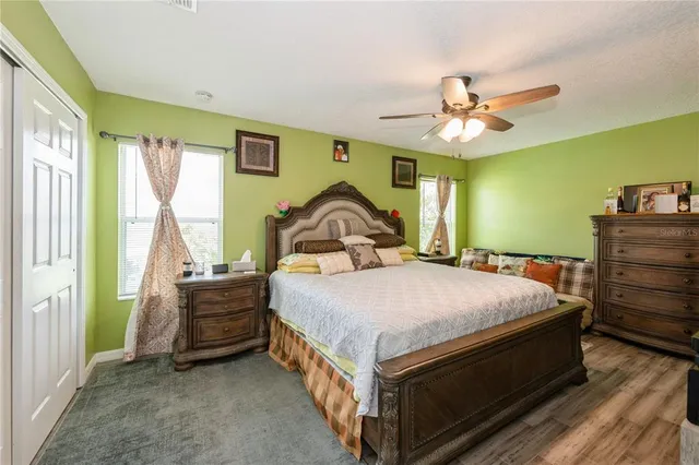 a bedroom with a bed dresser and a window