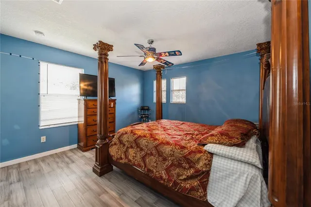 a bedroom with a bed and a chandelier