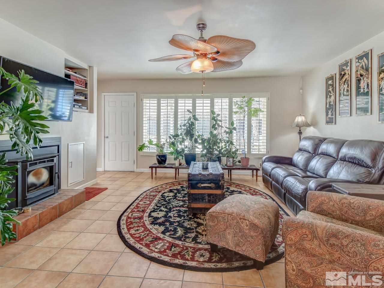 2345 Watt Street Reno, NV 89509 - Photo 5 of 25 a living room with furniture a chandelier and a fireplace