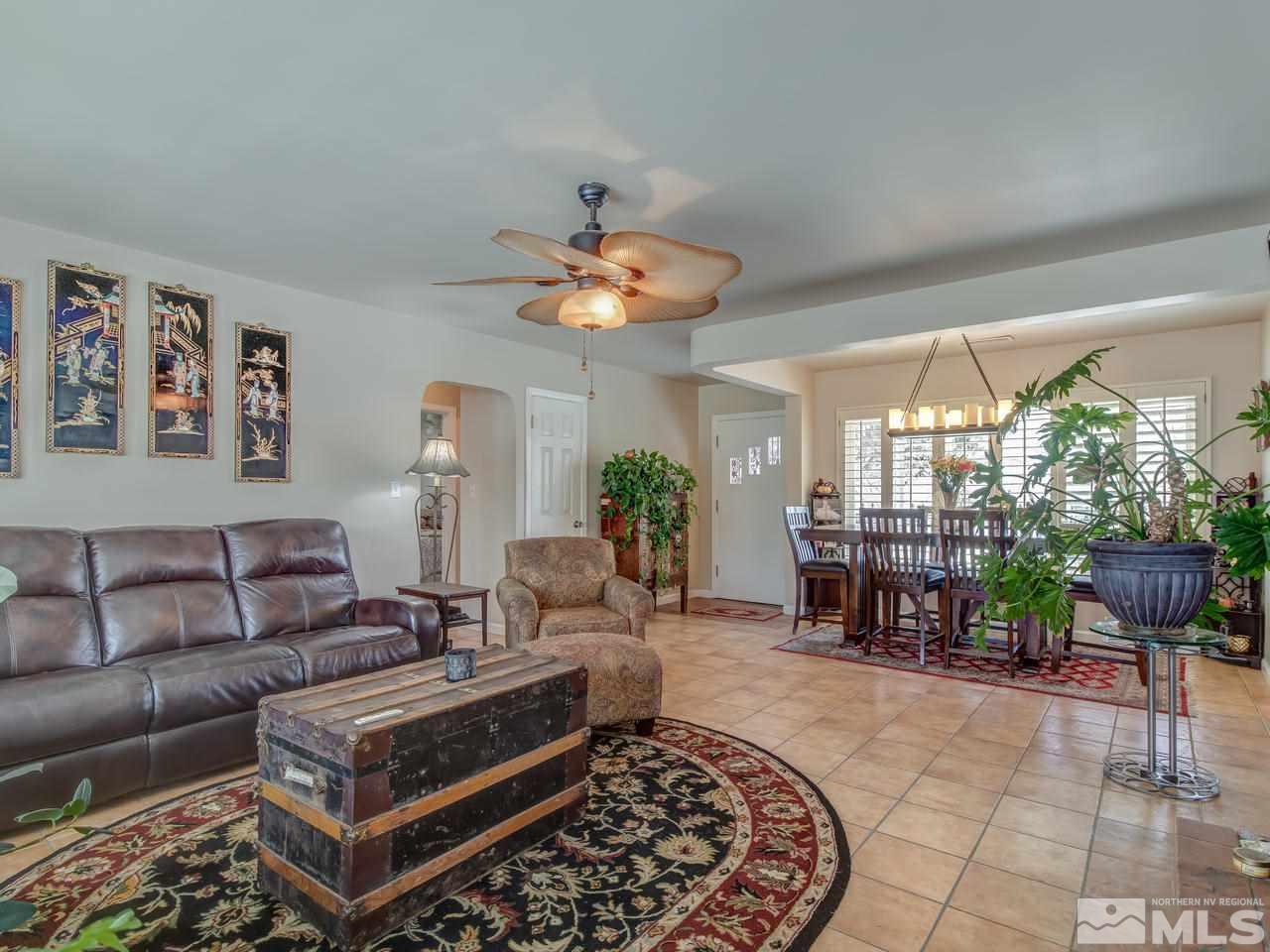 2345 Watt Street Reno, NV 89509 - Photo 6 of 25 a living room with furniture a chandelier and a fireplace