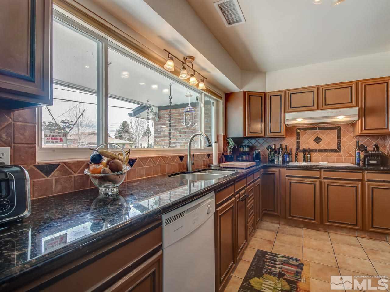 2345 Watt Street Reno, NV 89509 - Photo 8 of 25 a kitchen with granite countertop stainless steel appliances a sink and counter space