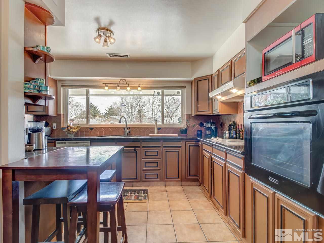 2345 Watt Street Reno, NV 89509 - Photo 10 of 25 a kitchen with stainless steel appliances granite countertop a stove and cabinets