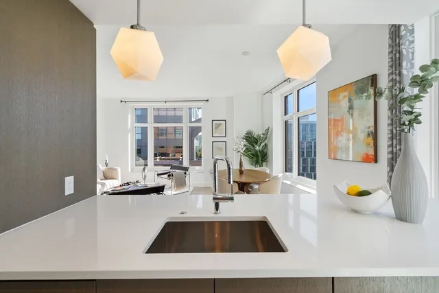 a view of kitchen island with furniture and chandelier
