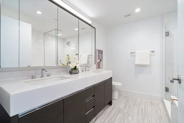 a bathroom with a double vanity sink mirror and double