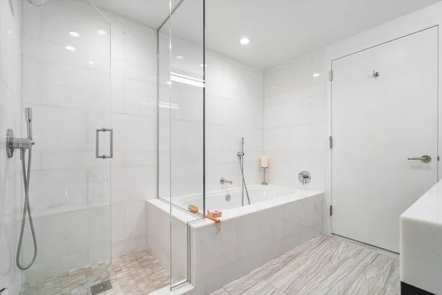 a bathroom with a bathtub and a shower