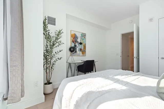 a bedroom with a bed and a window