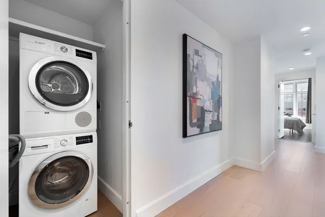 a view of a hallway with washer and dryer