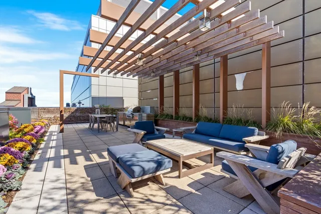 a building outdoor space with patio furniture and potted plants