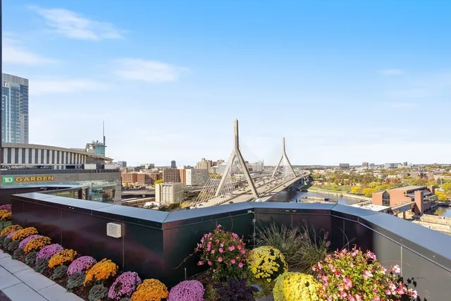 a view of roof deck with outdoor seating and city view