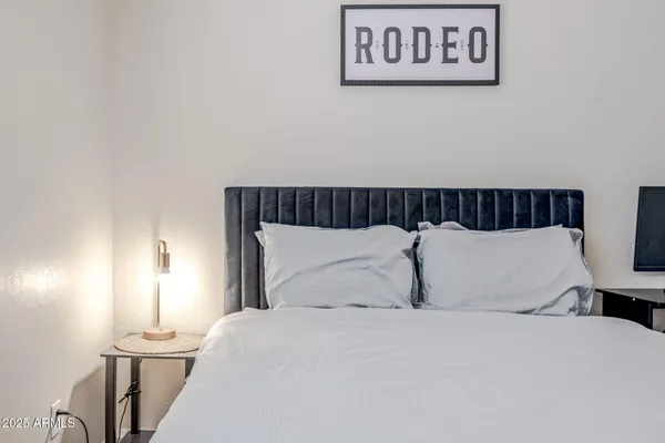 a bedroom with a bed and a lamp