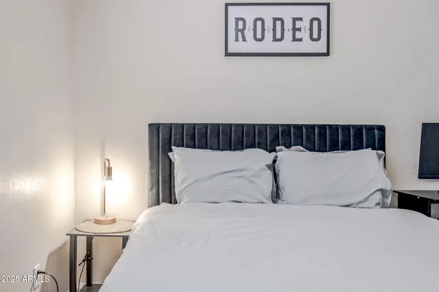 a bedroom with a bed and a lamp