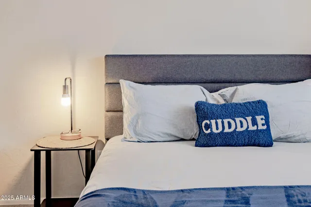 a bedroom with a bed and a table in it