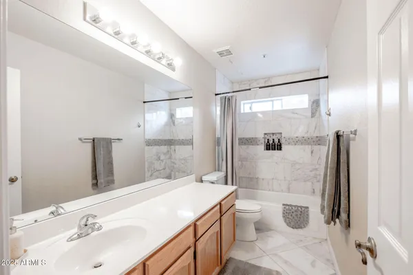 a bathroom with a sink and mirror with toilet