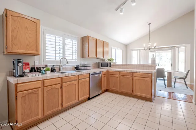 a kitchen with a sink window and cabinets