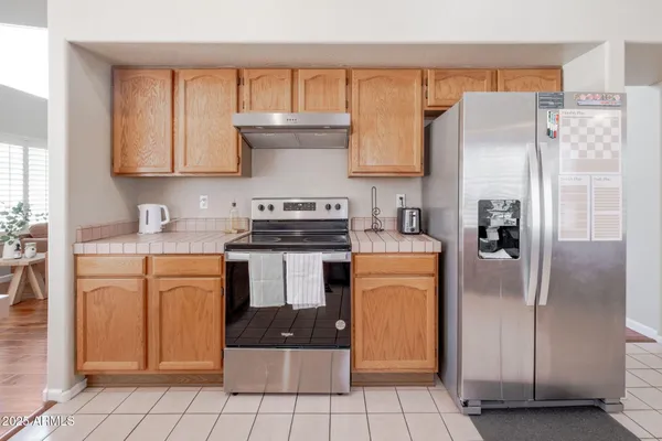 a kitchen with stainless steel appliances granite countertop a refrigerator sink and cabinets