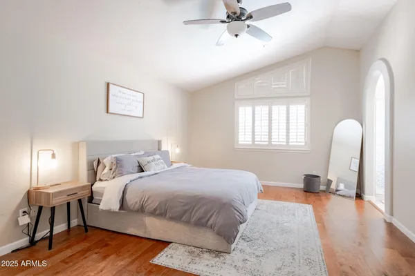 a bedroom with a bed and a window