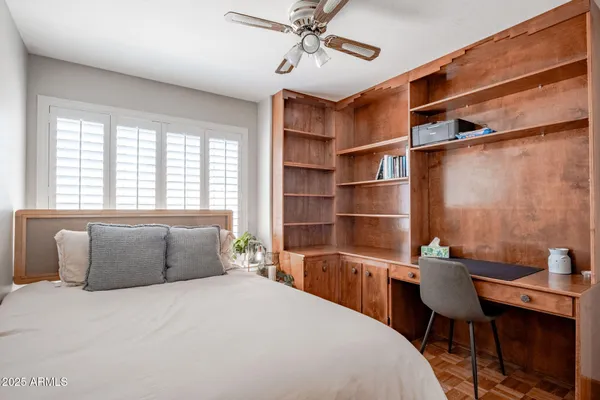 a bedroom with a large bed and a window
