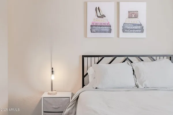 a bedroom with a bed and a night stand