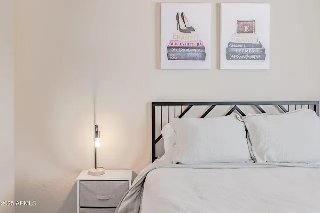 a bedroom with a bed and a night stand