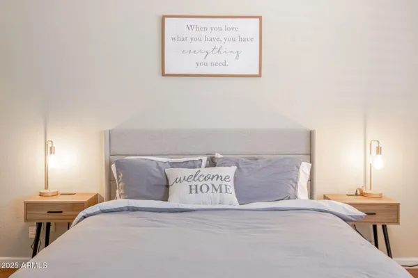 a bed sitting in a bedroom and lamp