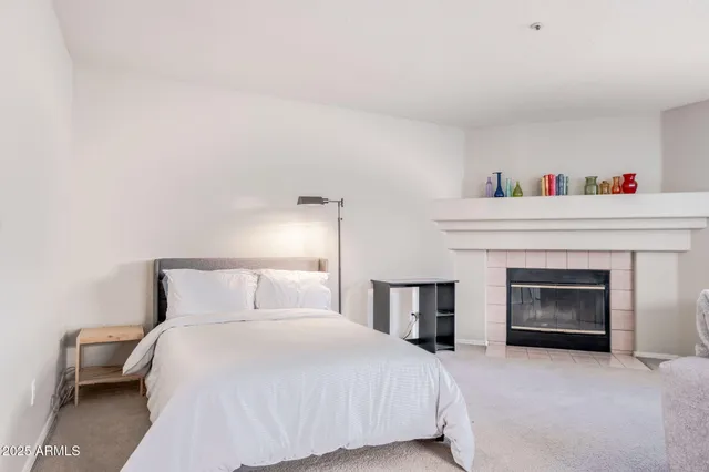 a bedroom with a bed and a fireplace