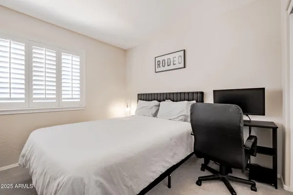 a bedroom with a bed and a desk