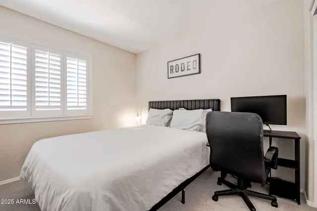 a bedroom with a bed and a desk